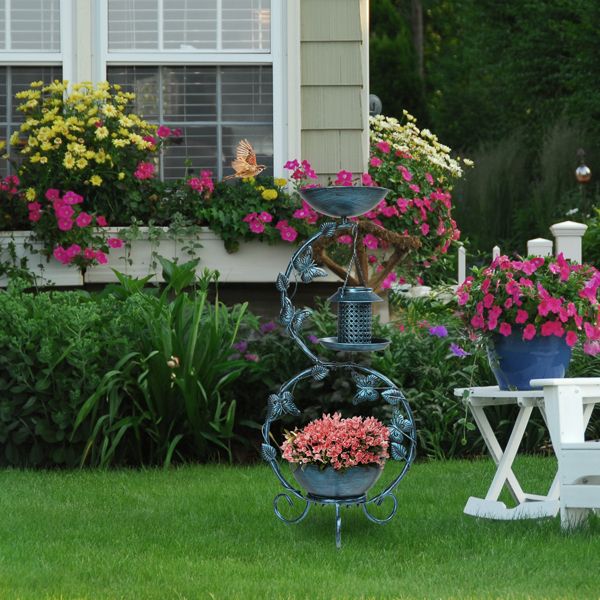 Bird Bath with Solar Bird Feeder and Planter Pedestal In A Garden With Pink Flowers