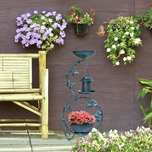 Bird Bath with Solar Bird Feeder and Planter Pedestal In A Garden Beside A Bench