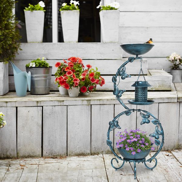 Bird Bath with Solar Bird Feeder and Planter Pedestal In A Garden With Purple Flowers