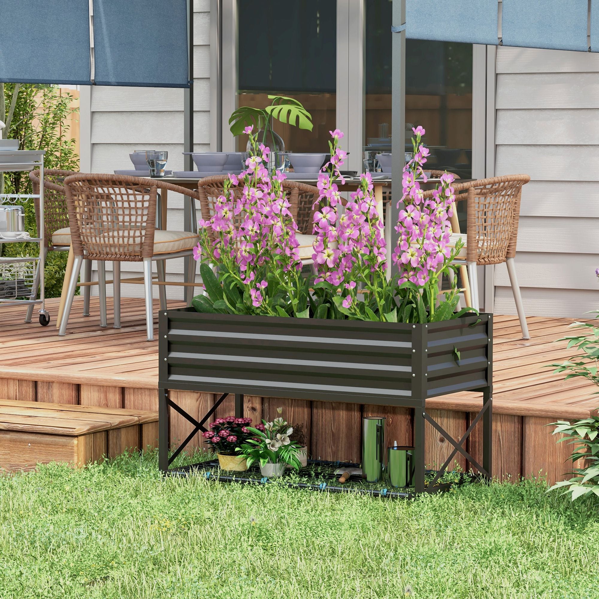 Black Galvanized Raised Garden Bed With Pink Flowers In