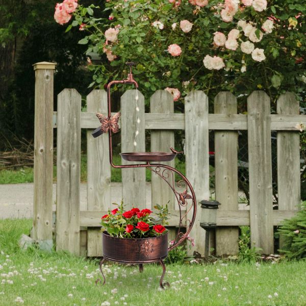 Vintage Bronze Bird Bath with Solar Light and Planter Garden Setting with Red Flowers