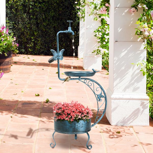 Vintage Metal Bird Bath with Solar Light and Planter On A Patio With Pink Flowers